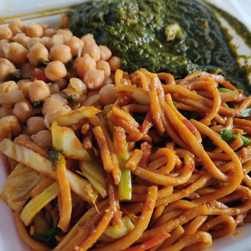 Tibet Kitchen's chickpea curry, green spinach, and stir-fried noodles with vegetables.